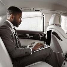 African,American,Businessman,Sits,In,The,Backseat,Of,A,Car,